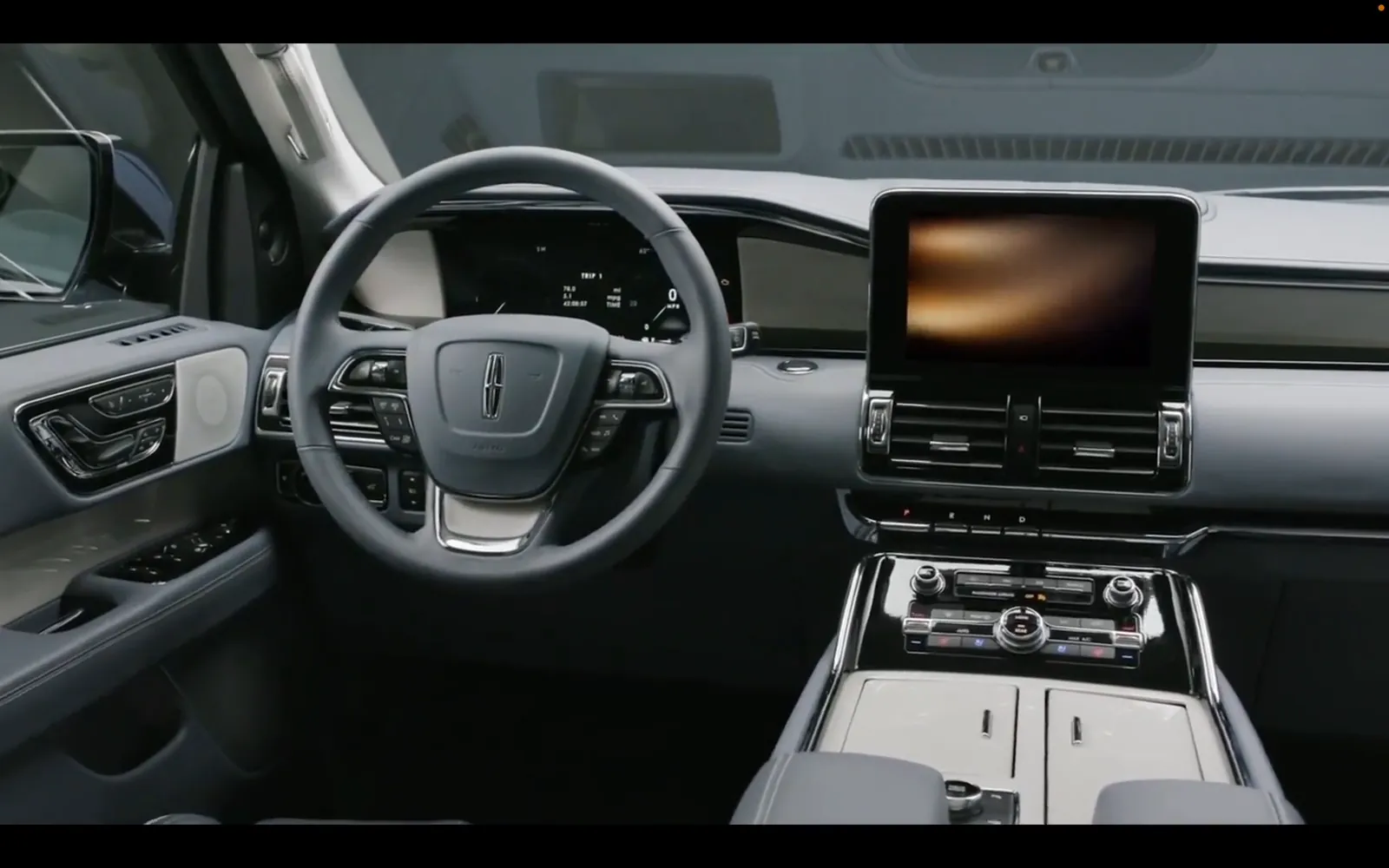 A frame from the Lincoln film: the Navigator cabin, wheel and center stack